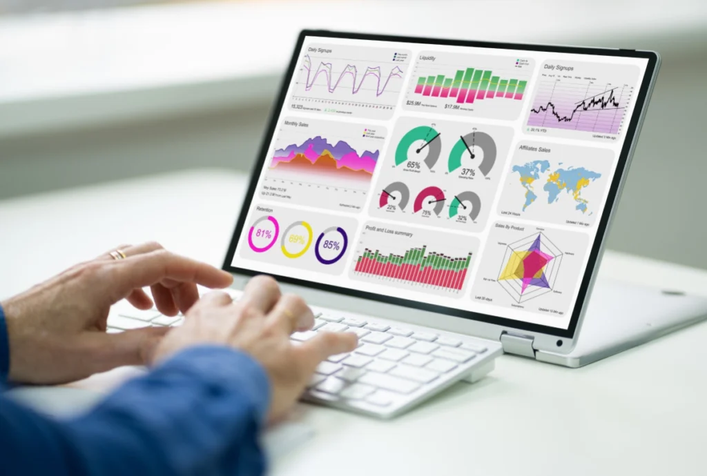 man behind a laptop analyzing data and graphs
